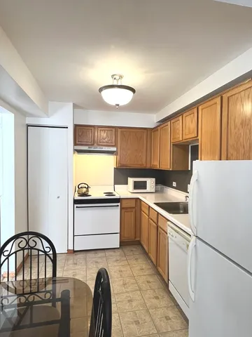 a kitchen with a white cabinets and white appliances
