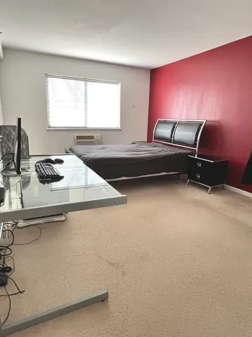 a bedroom with furniture and window