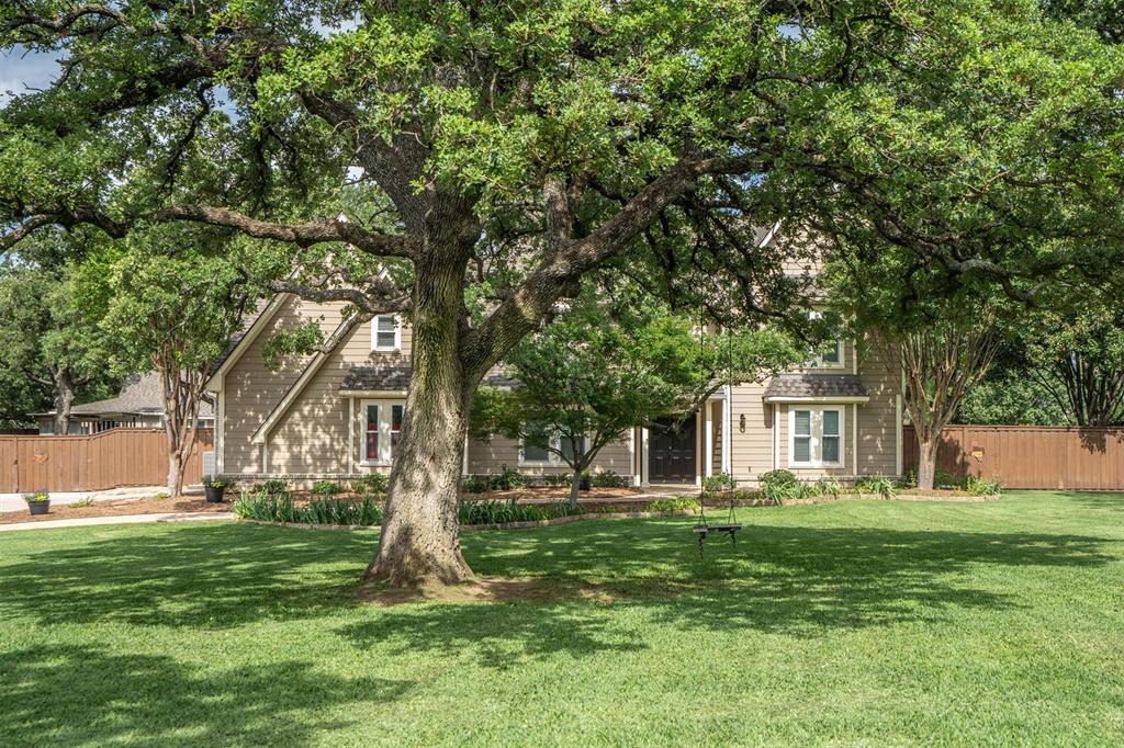 410 Simmons Road Double Oak, TX 75077 - Photo 5 of 40 Mature trees frame this charming home, offering shade and exceptional privacy.