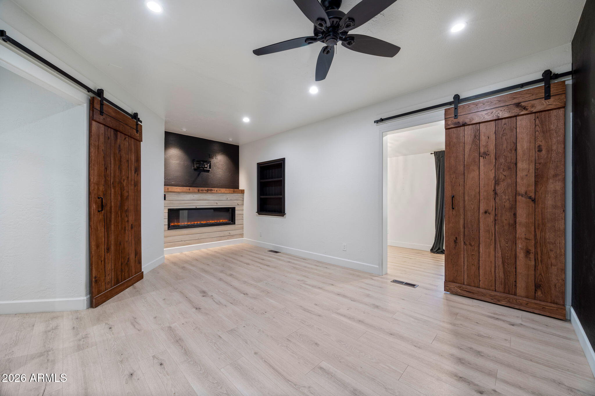 3310 Tonto Drive Overgaard, AZ 85933 - Photo 13 of 54 an empty room with wooden floor cabinet and windows