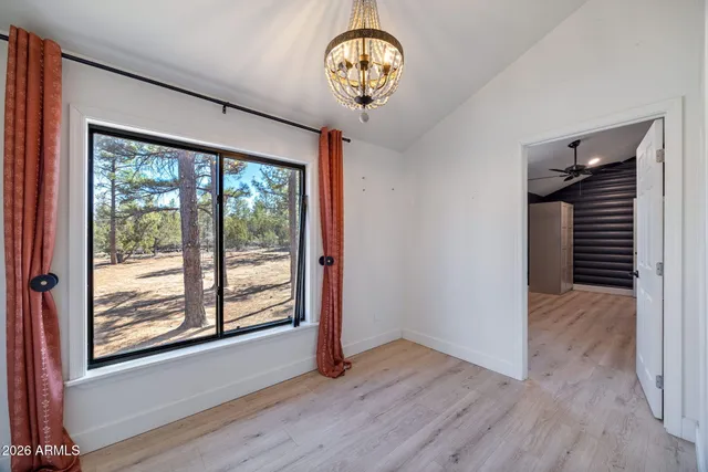 a view of a livingroom with a ceiling fan and window