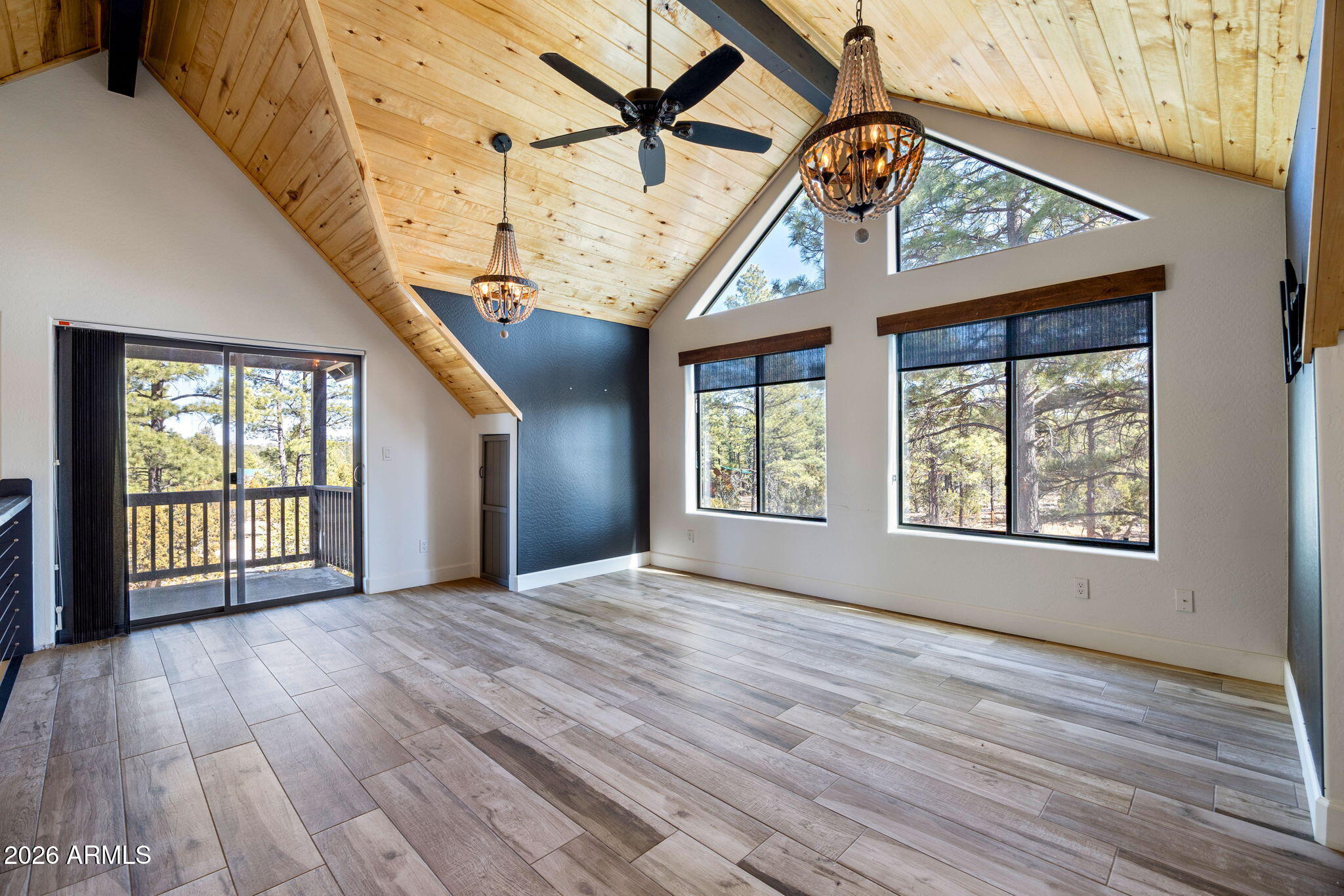 3310 Tonto Drive Overgaard, AZ 85933 - Photo 25 of 54 a view of an empty room with wooden floor and a window