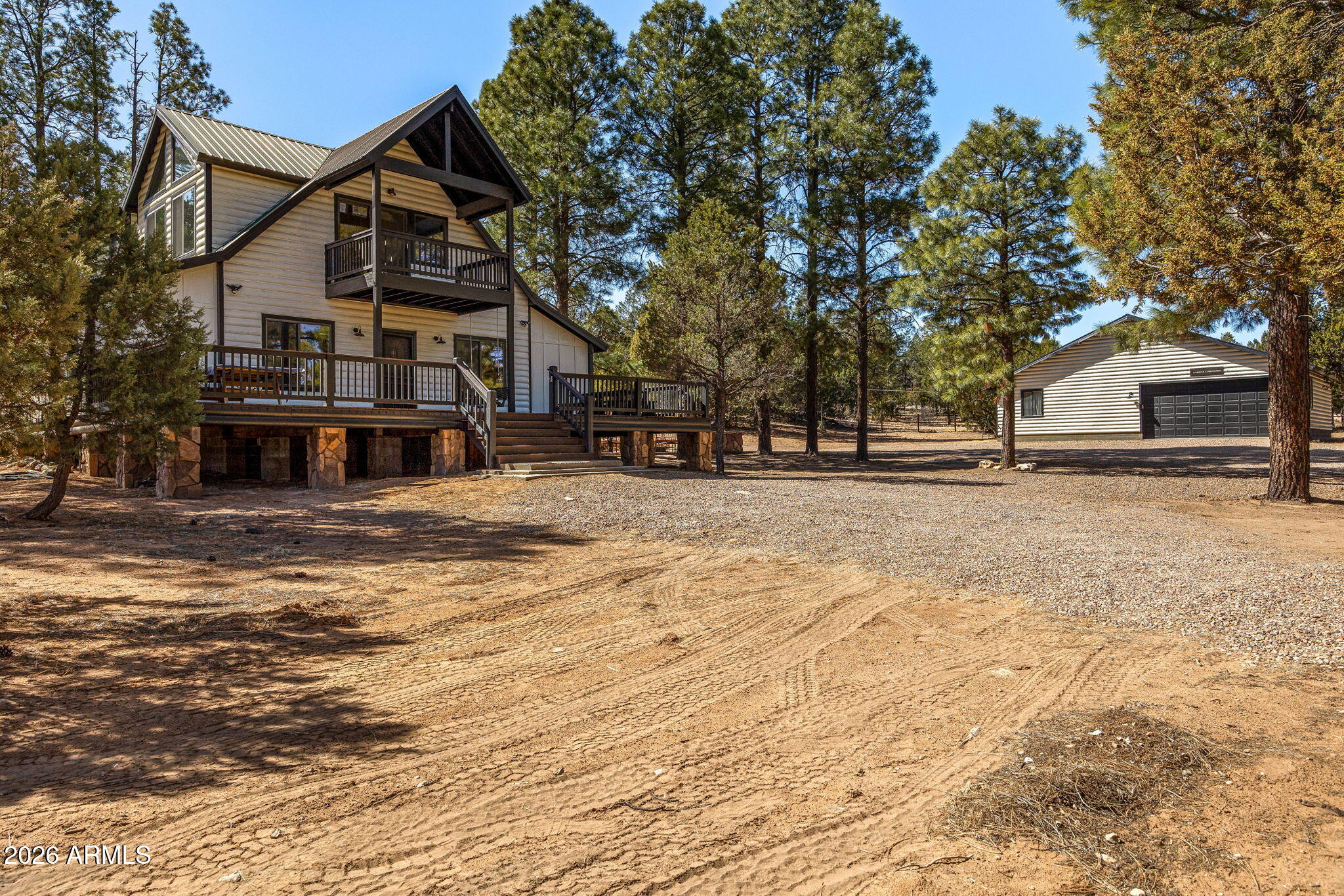 3310 Tonto Drive Overgaard, AZ 85933 - Photo 3 of 54 a front view of a building with large trees