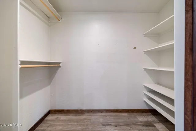 a row of white house with large trees and outdoor seating