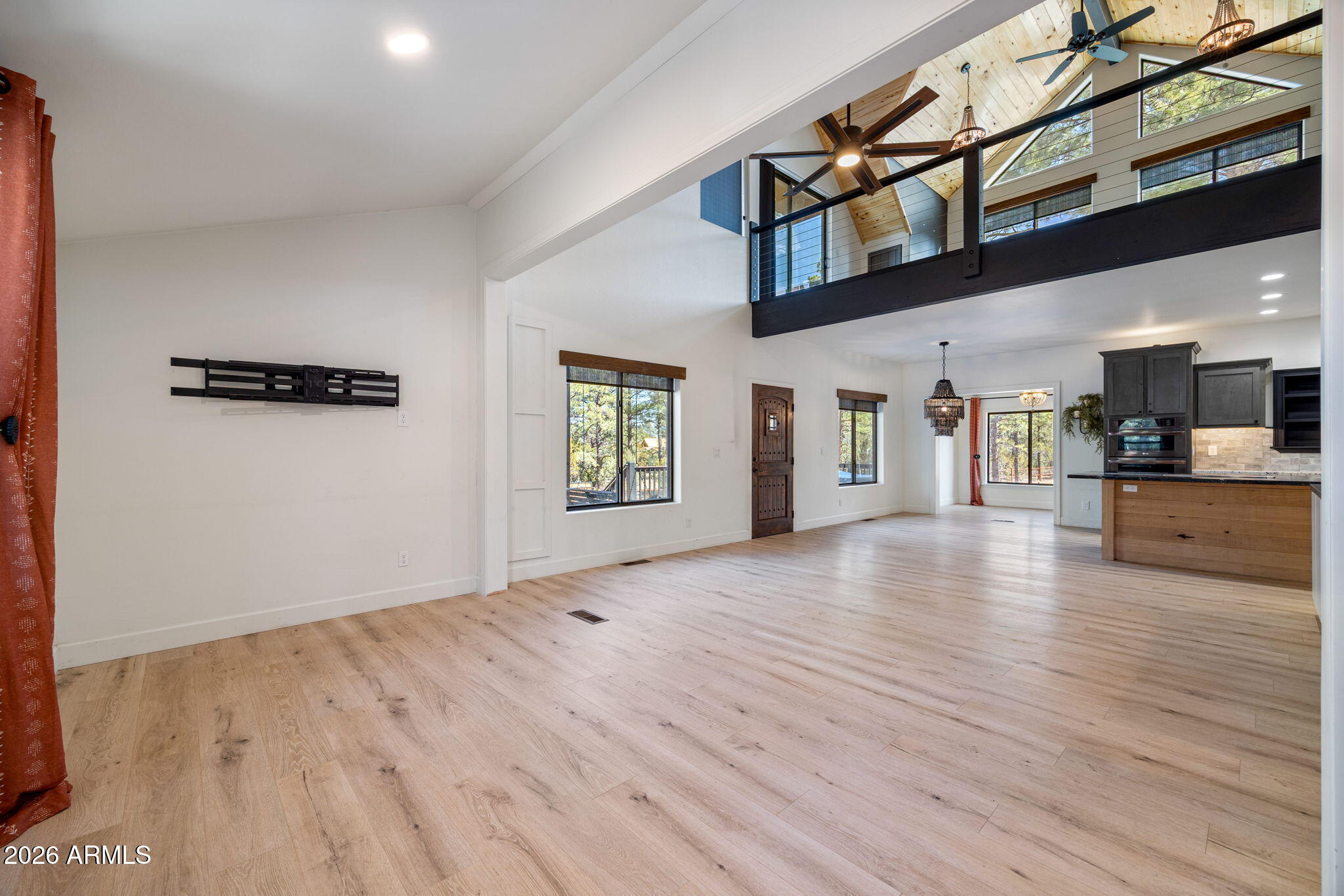 3310 Tonto Drive Overgaard, AZ 85933 - Photo 7 of 54 a view of a hallway with wooden floor and a kitchen