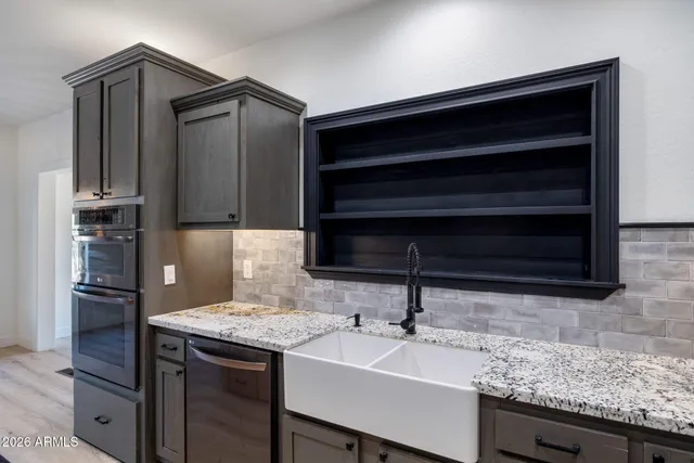 a kitchen with a sink and a refrigerator