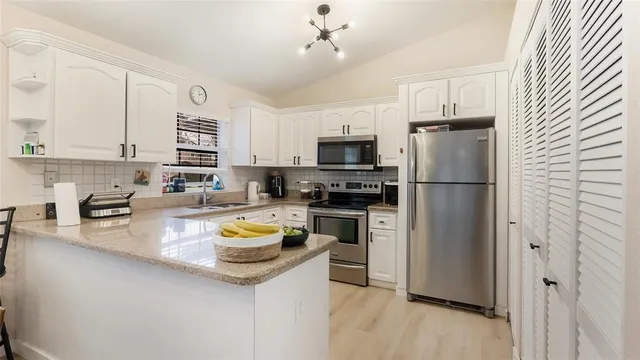 a kitchen with a refrigerator and a stove