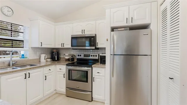 a living room with furniture a rug and a wall painting
