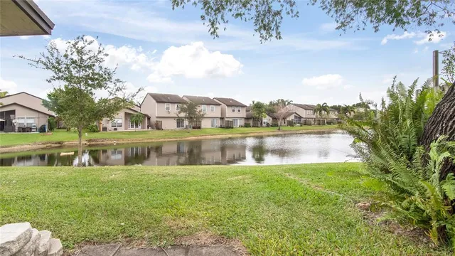 a small garden with a bench in front of the house