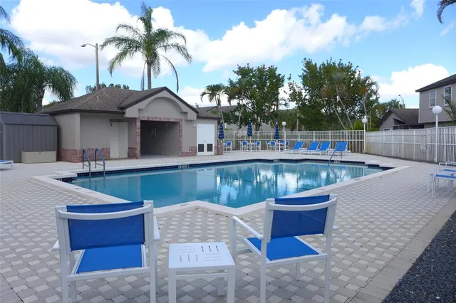 a view of pool with a yard