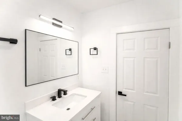 a bathroom with a sink a mirror and shower