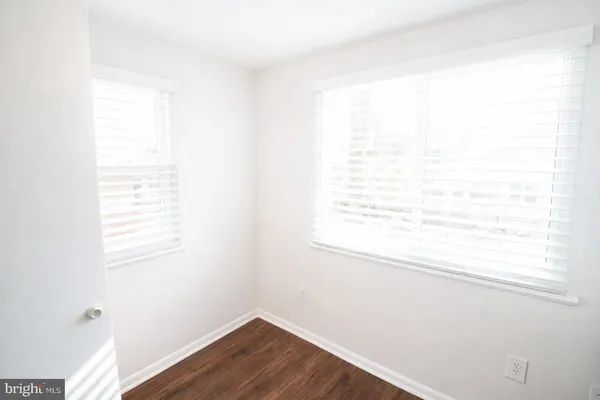 a view of a small space with wooden floor and a window