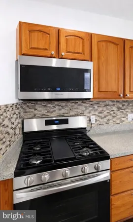 a stove top oven sitting inside of a kitchen