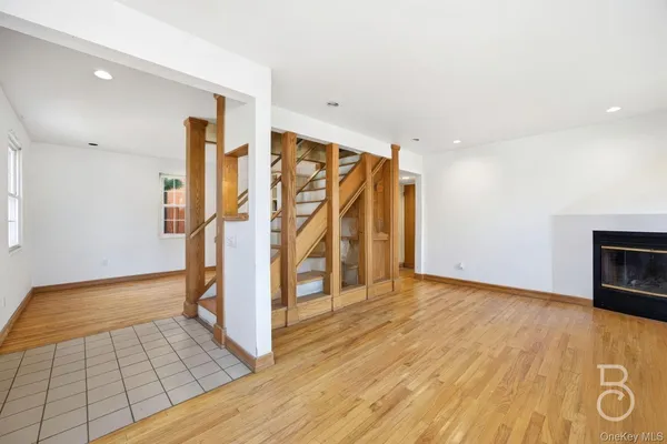wooden floor in an empty room with a fireplace
