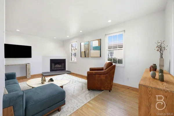 a living room with furniture a flat screen tv and a fireplace