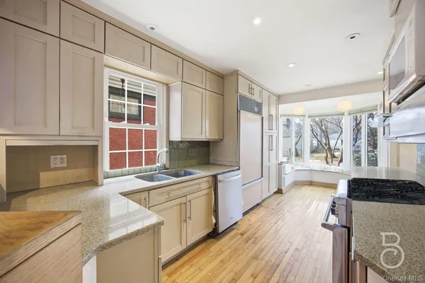 a kitchen that has a sink and a stove in it