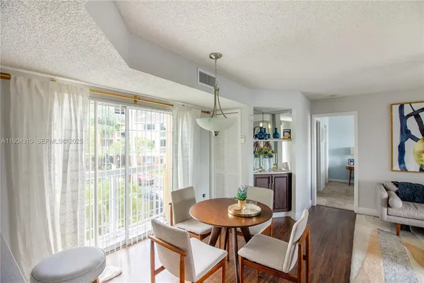 a view of a dining room with furniture window and wooden floor
