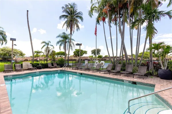a view of a house with swimming pool and sitting area