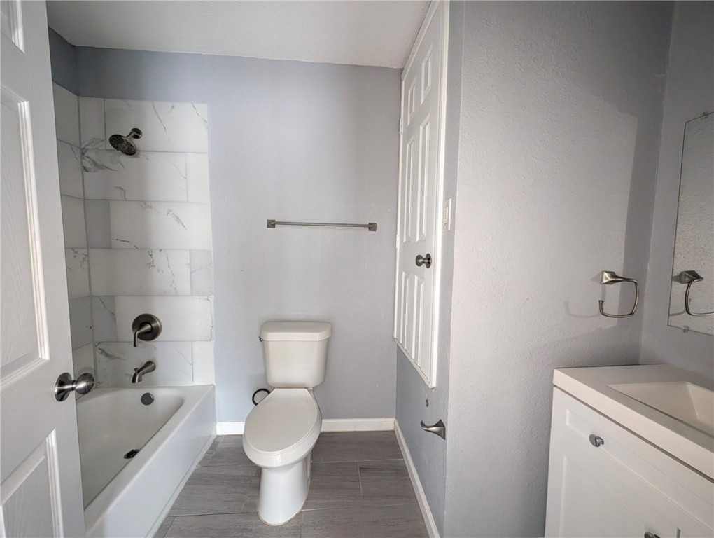 4709 Archer Drive Corpus Christi, TX 78415 - Photo 13 of 17 a bathroom with a toilet sink and shower