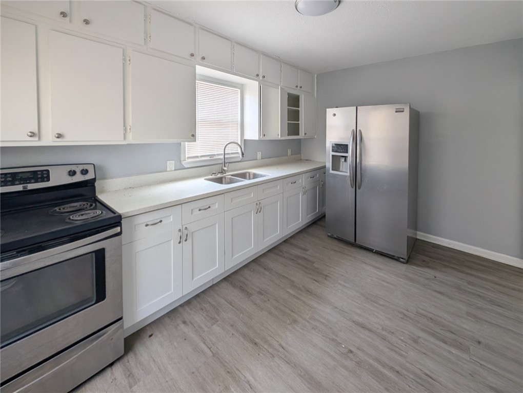 4709 Archer Drive Corpus Christi, TX 78415 - Photo 5 of 17 a kitchen with a sink cabinets stainless steel appliances and a window