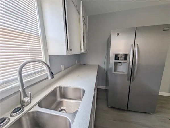a kitchen with a refrigerator and a sink