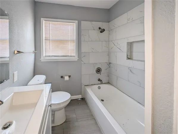 a bathroom with a bathtub and toilet