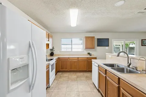 a kitchen with a sink stove and refrigerator
