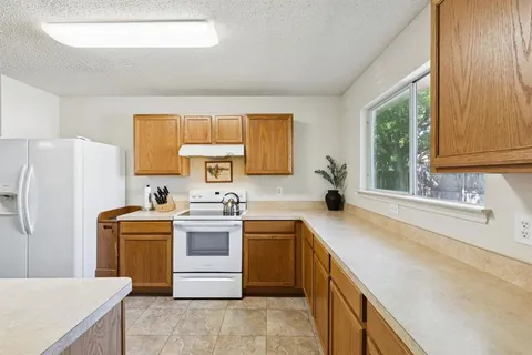 a kitchen with a stove sink and refrigerator