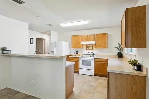 a kitchen with a sink stove and refrigerator