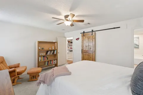 a view of walk in closet with clothes