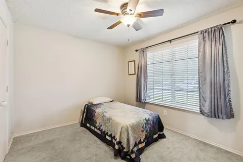 a bedroom with a large bed and a window