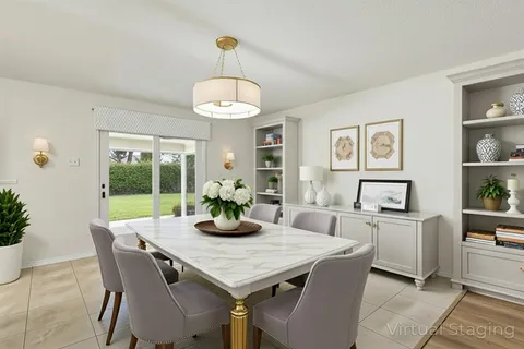 a view of a dining room with furniture a chandelier and wooden floor
