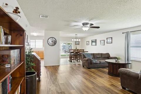 a living room with furniture and a wooden floor