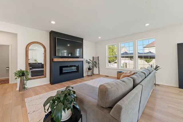 a living room with furniture a fireplace and a flat screen tv