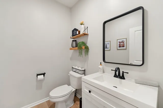 a bathroom with a sink mirror and toilet