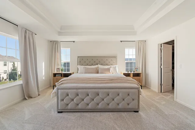 a bedroom with a bed and a large mirror