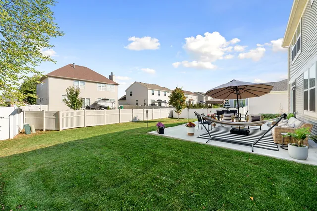 a view of a house with backyard porch and sitting area