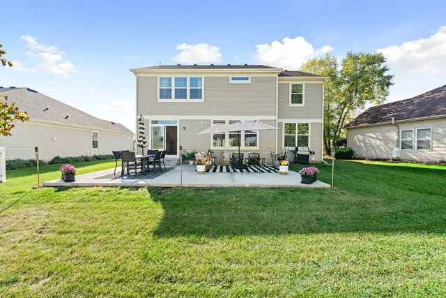 a front view of house with yard and outdoor seating