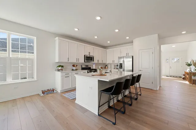 a kitchen with a sink appliances and wooden floor