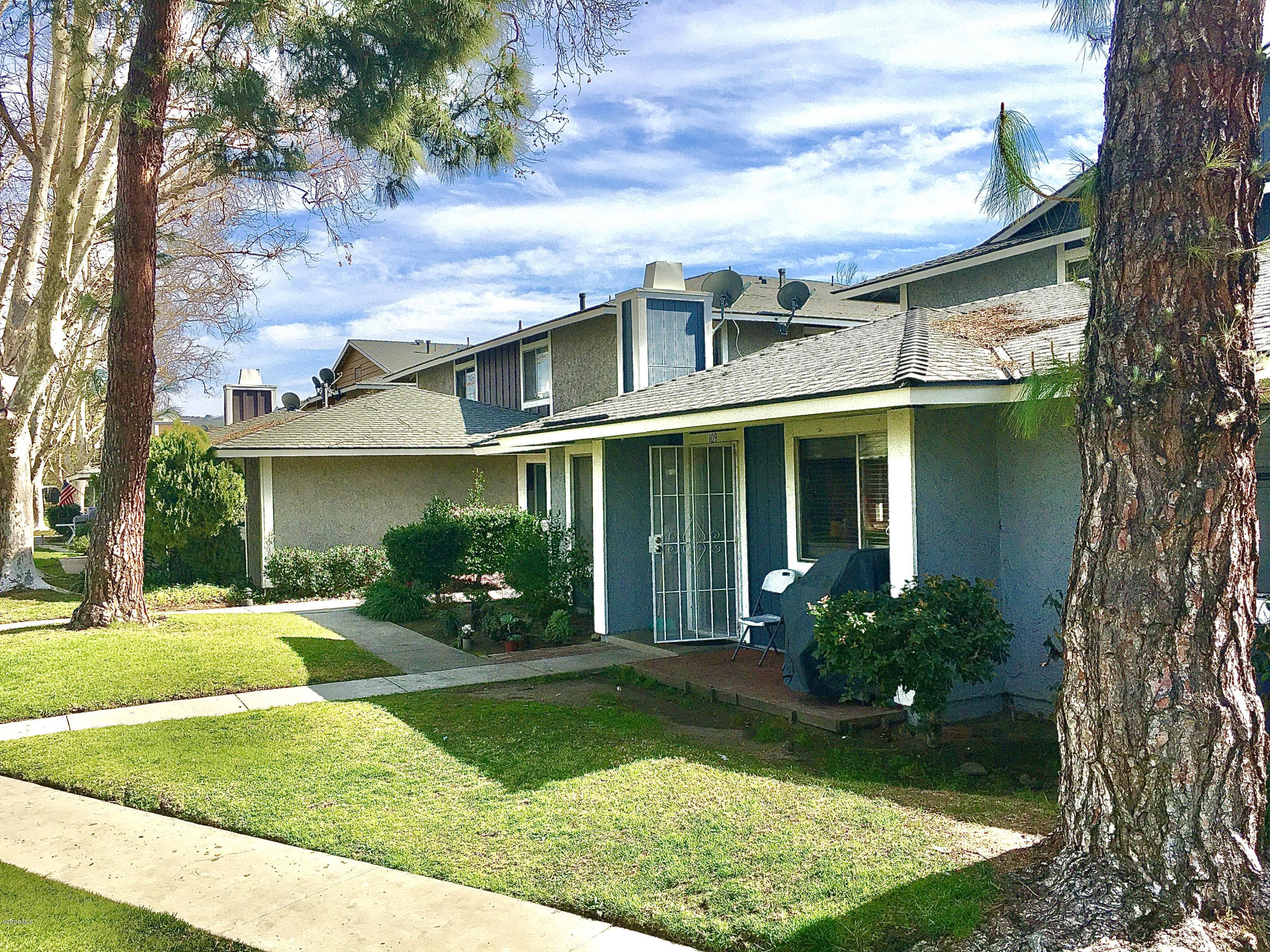 520 Spring Road, Unit 109 Moorpark, CA 93021 - Photo 1 of 8 front view of a house with a yard