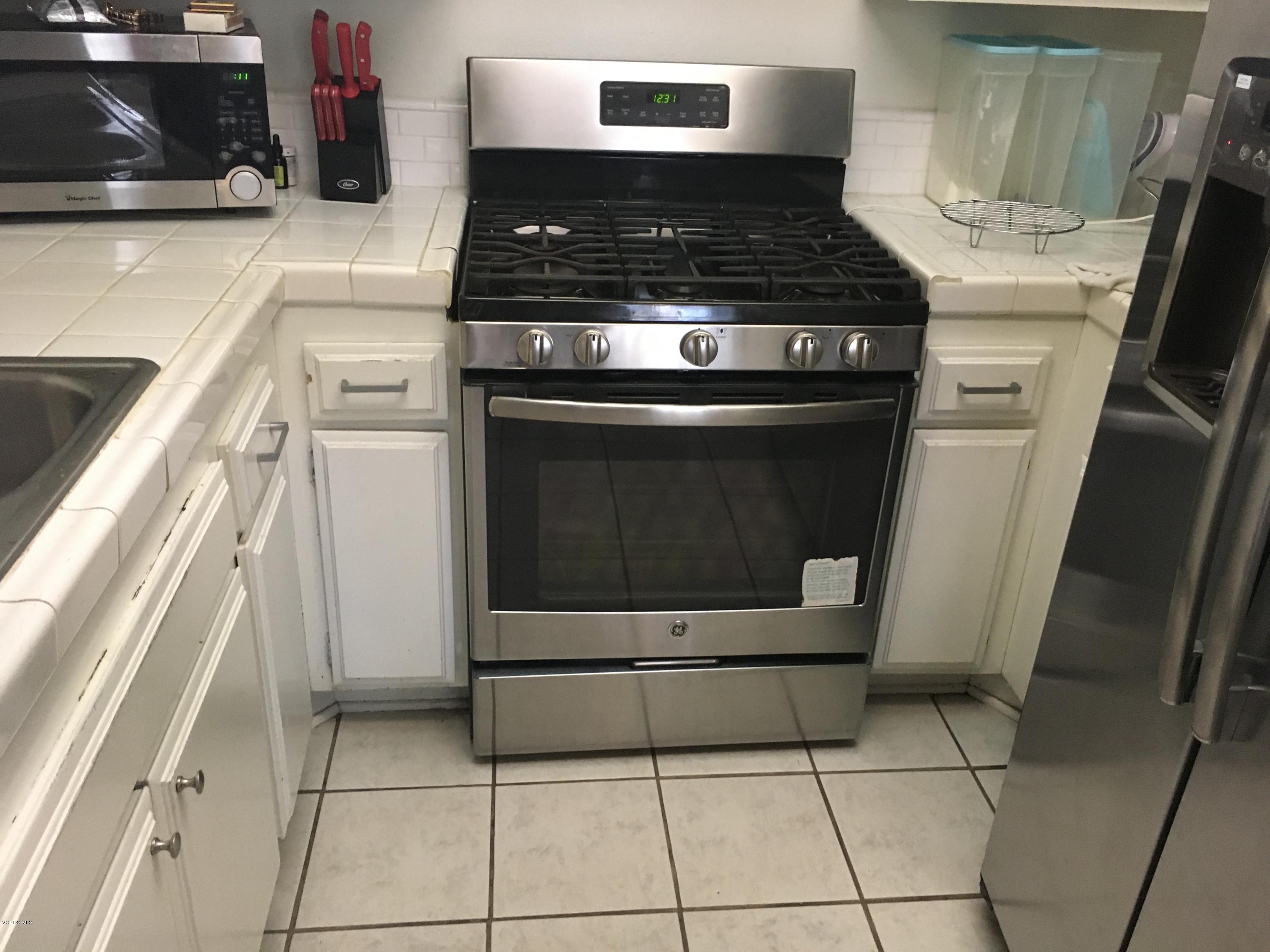 520 Spring Road, Unit 109 Moorpark, CA 93021 - Photo 2 of 8 a stove top oven sitting inside of a kitchen