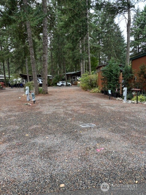 1546 Reservation Road Southeast, Unit 219 Olympia, WA 98513 - Photo 1 of 20 a view of outdoor space with deck and trees