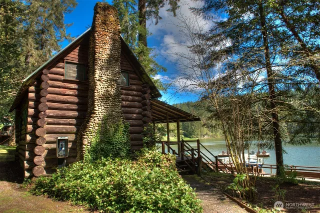 a view of a lake with couches chairs and a yard