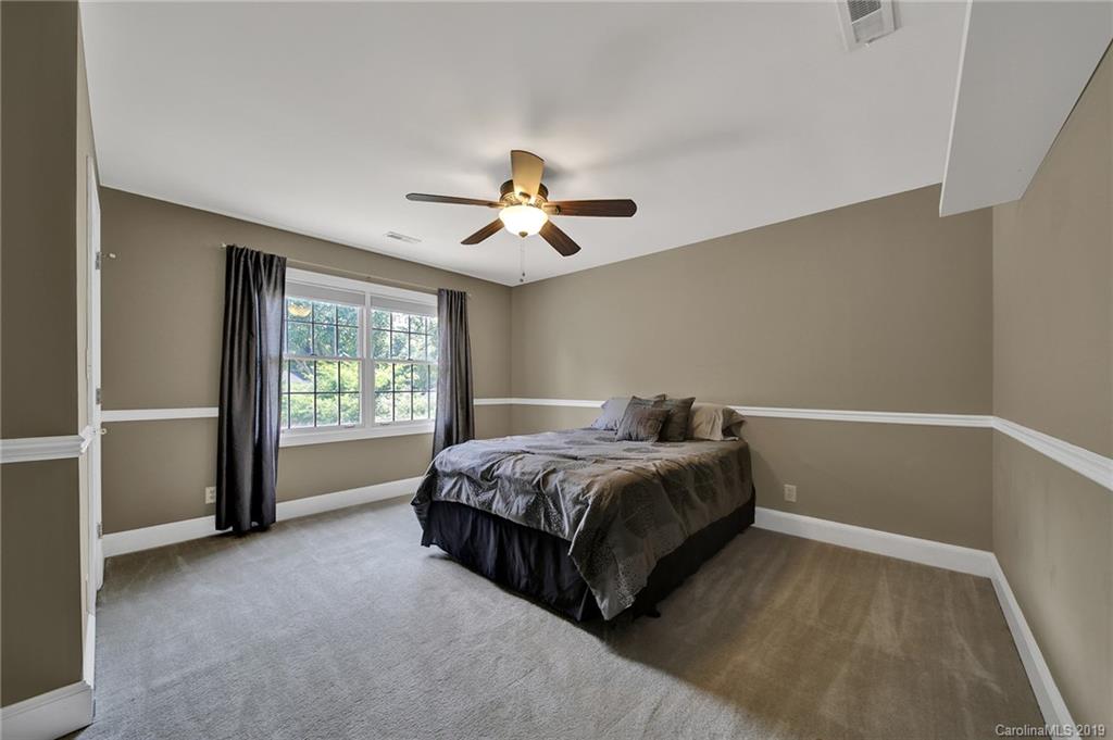 286 South Downs Way, Unit 13 Fort Mill, SC 29708 - Photo 22 of 33 a spacious bedroom with a bed and a ceiling fan