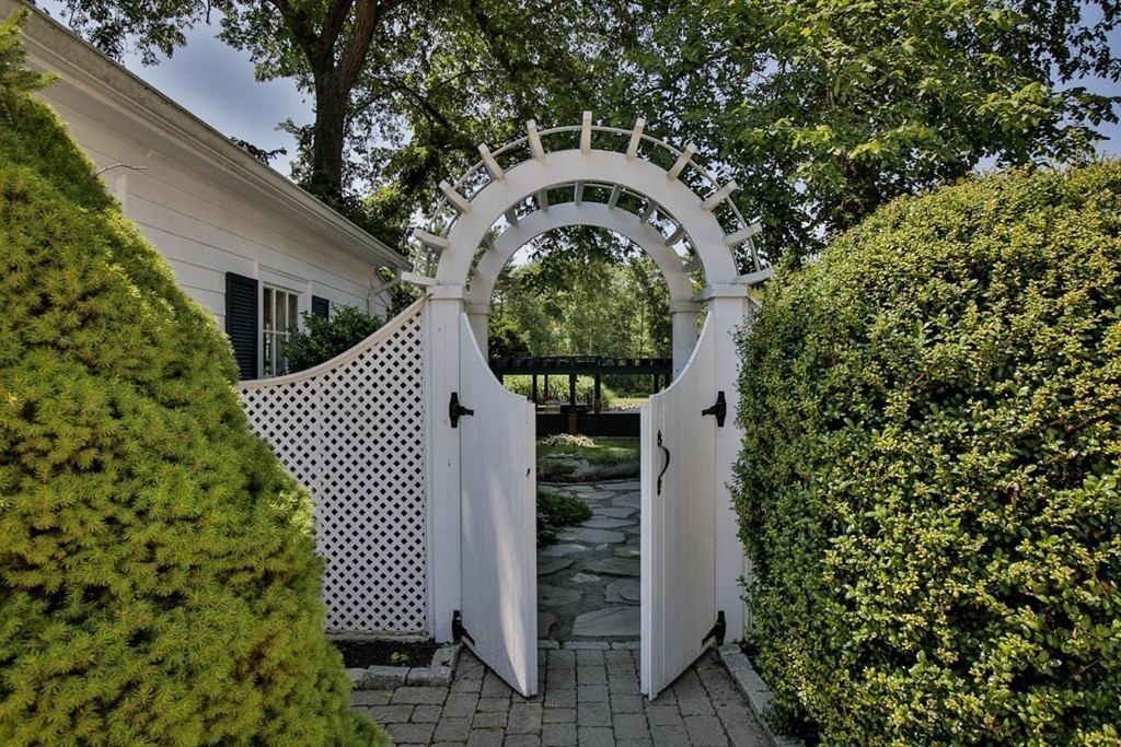 1129 Walnut Plain Road Rochester, MA 02770 - Photo 1 of 29 a front view of a house with garden