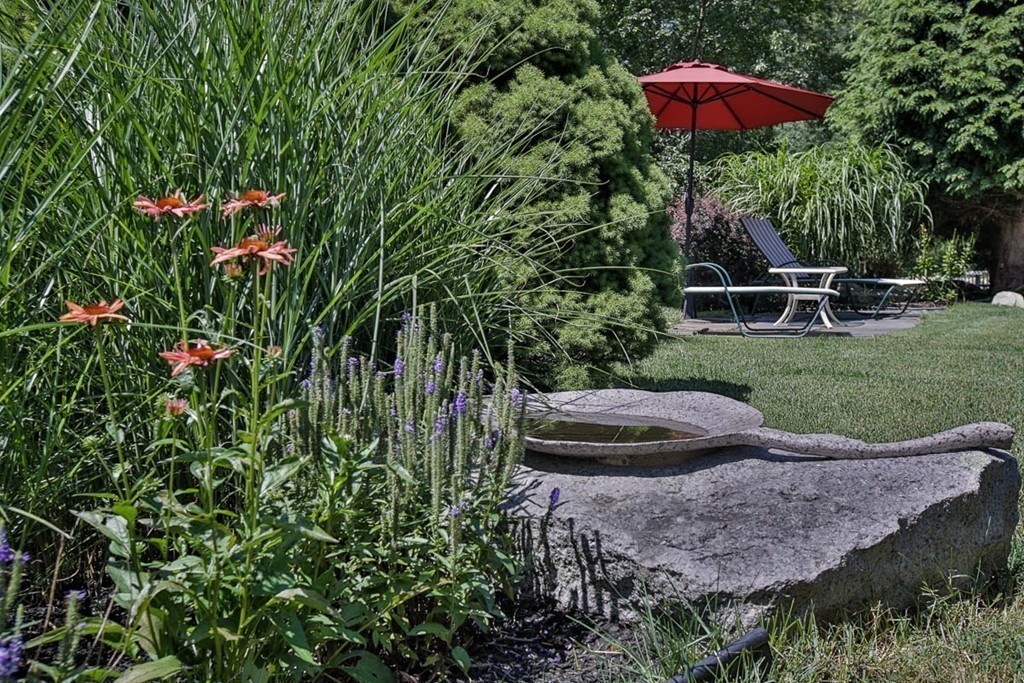 1129 Walnut Plain Road Rochester, MA 02770 - Photo 14 of 29 a view of a backyard with plants and a yard