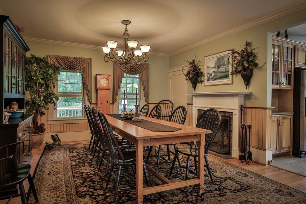 1129 Walnut Plain Road Rochester, MA 02770 - Photo 7 of 29 a view of a dining room with furniture a chandelier and window