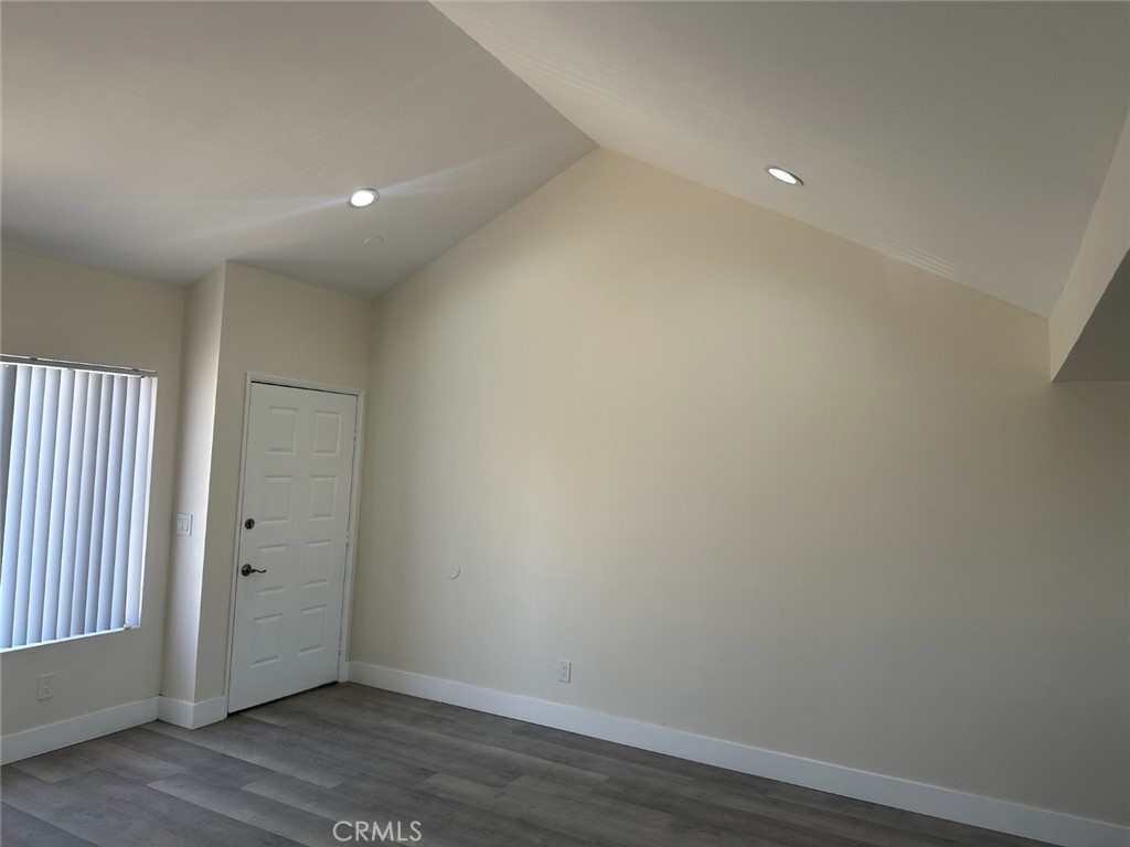 44155 10th Lancaster, CA 93534 - Photo 7 of 15 an empty room with wooden floor and windows