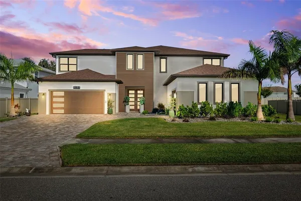 a front view of a house with a yard and garage