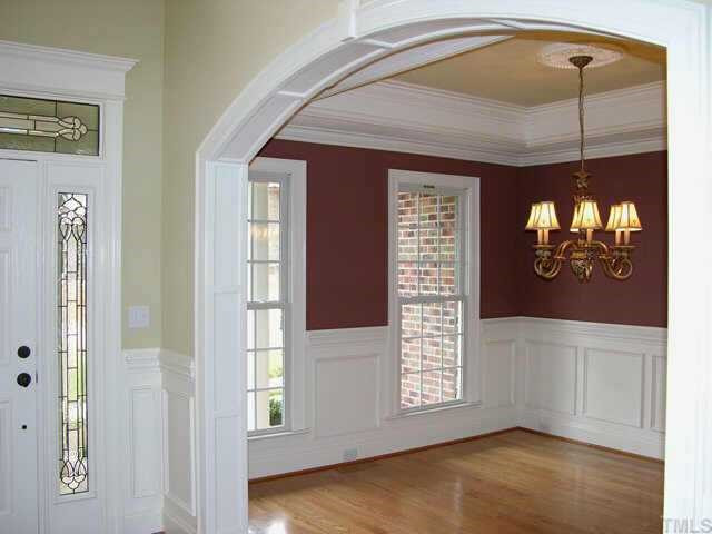 3313 Cotton Road Raleigh, NC 27601 - Photo 7 of 10 Formal living room with wainscoting, trey ceiling and double crown molding, and medallion lighting centerpiece is adjacent to bright open entry. Don't miss the exquisite leaded-glass windows surrounding the front door. Other